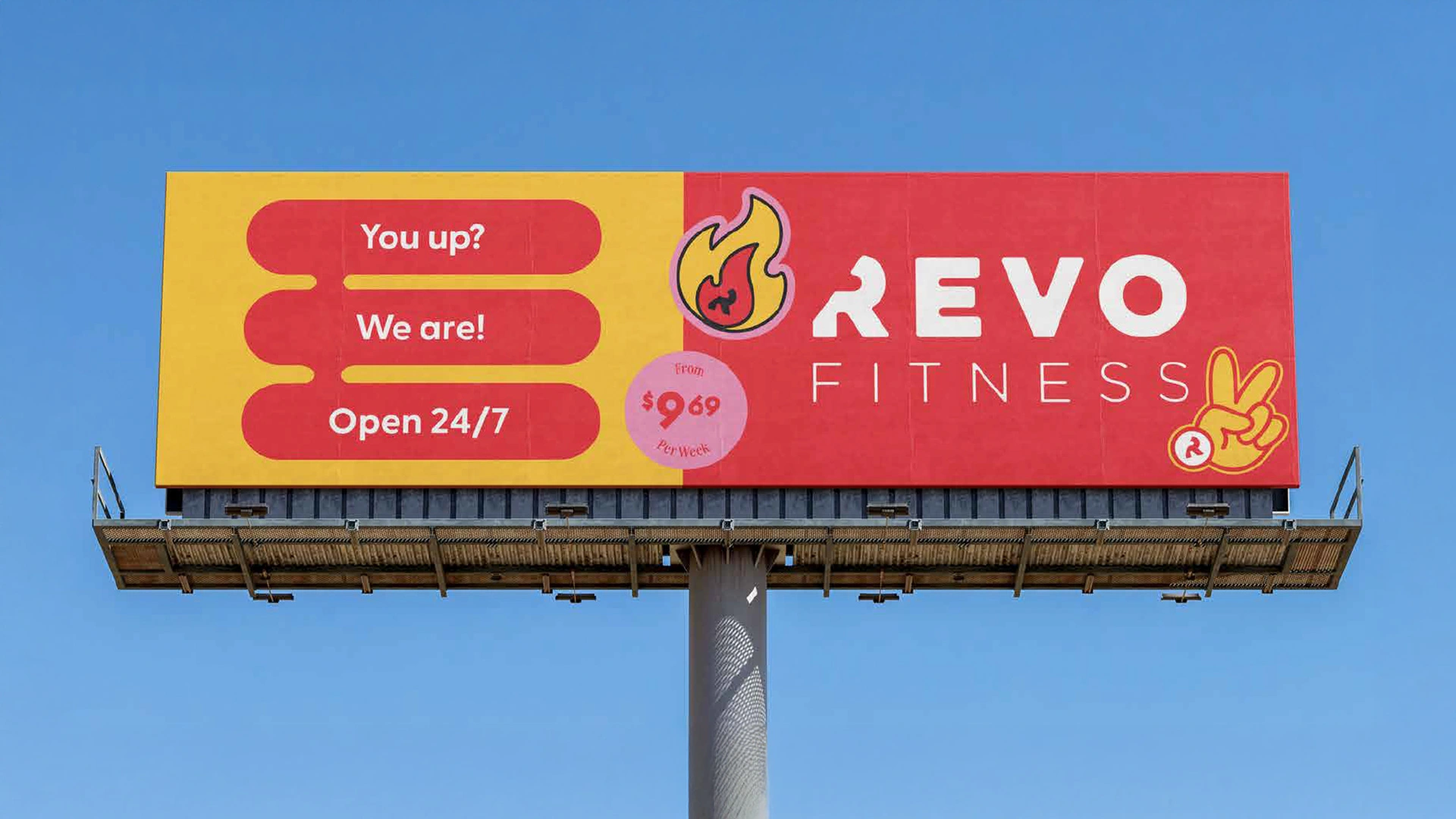 Revo Fitness billboard mockup showing 'You up? We are! Open 24/7' on yellow background against blue sky