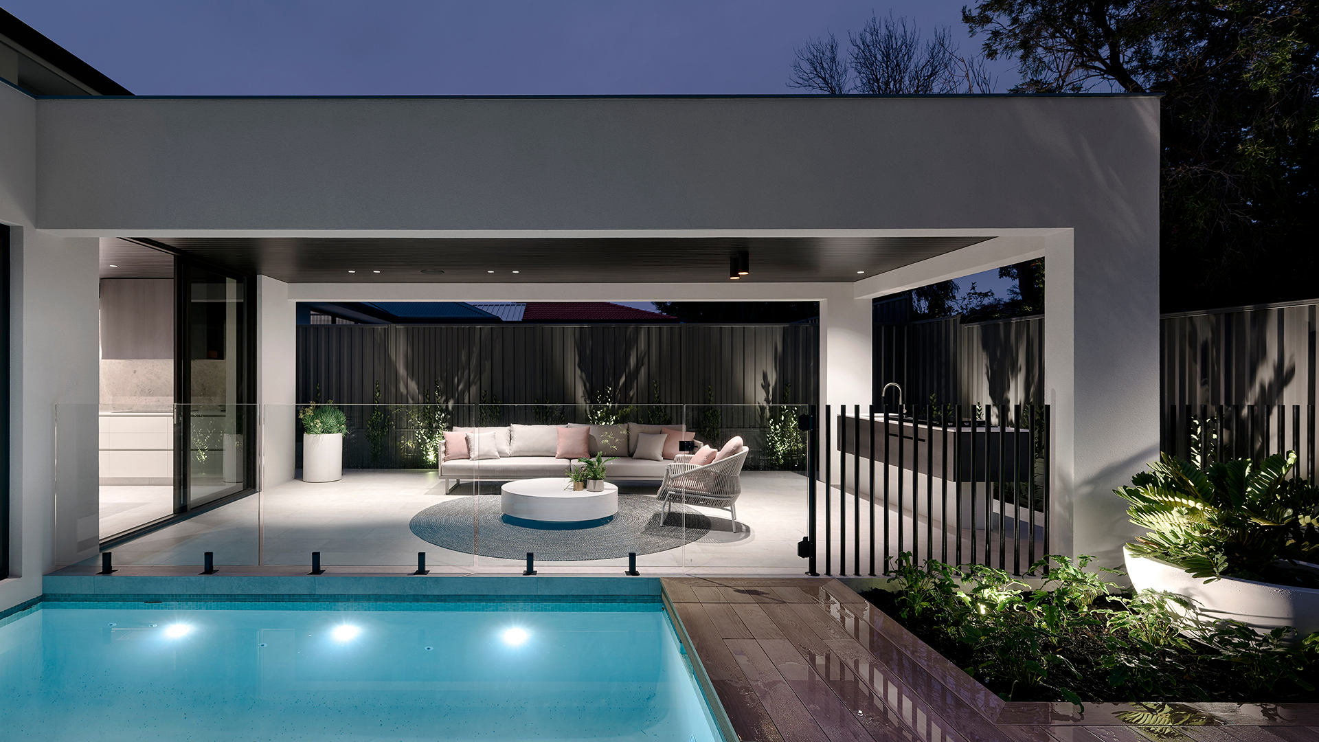 Modern luxury house exterior with swimming pool and palm trees at dusk, Averna property photography