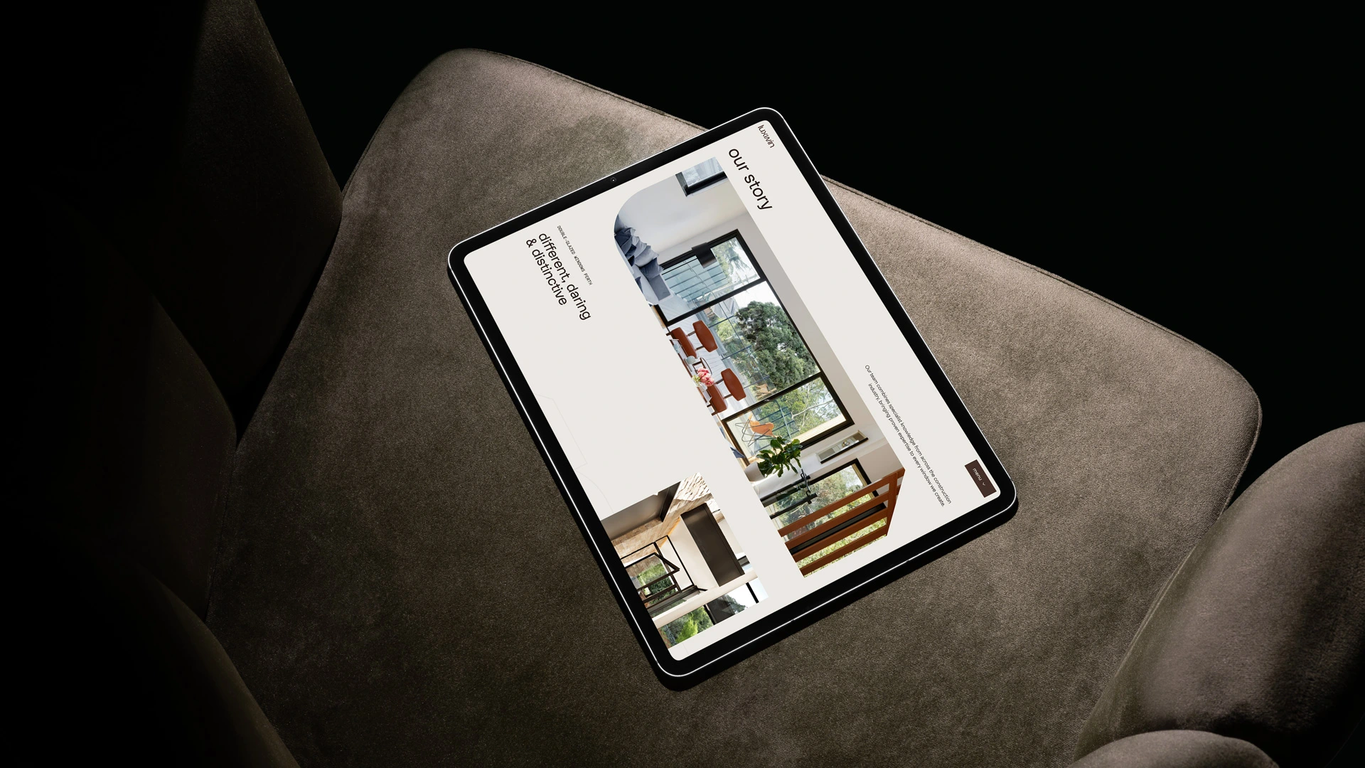 Tablet mockup showing Luxwin brochure or website content resting on a sofa in a warm lifestyle setting