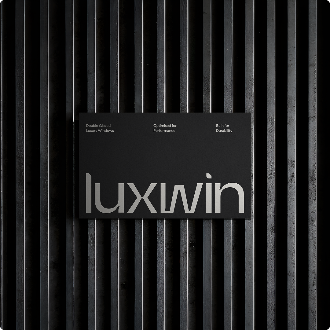 Luxwin wordmark logo in white on a dark vertically ribbed or textured background, minimal brand presentation