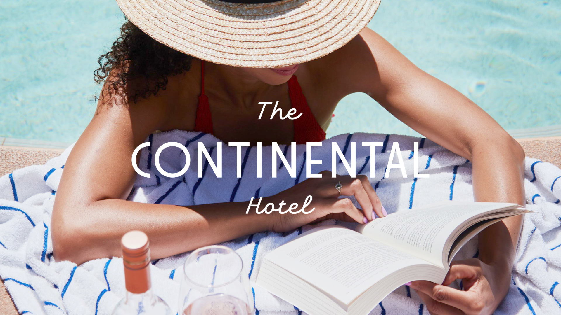 Woman in a white wide brim hat in an elegant pool setting with The Continental Hotel text overlay